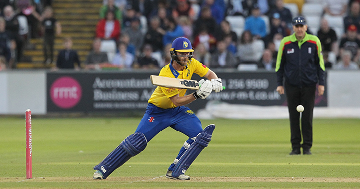 Durham cricket player batting ball away